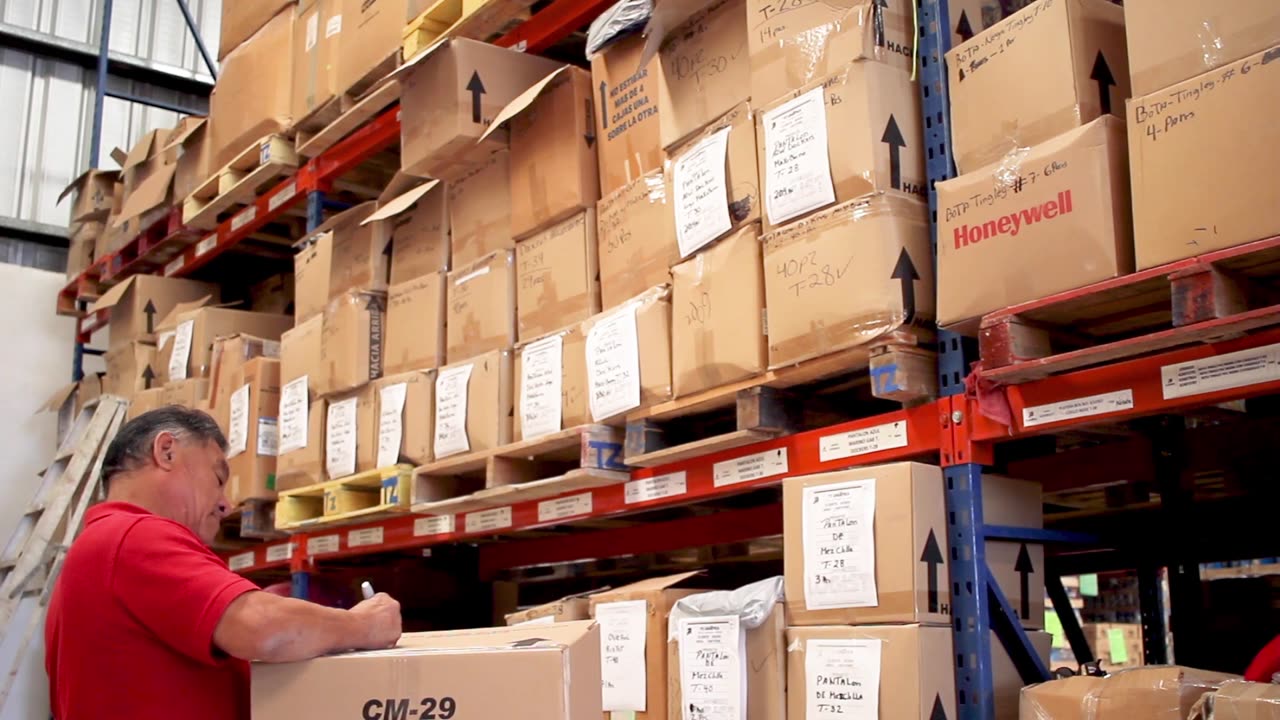Warehouse worker handling palletized inventory during a supplier pickup